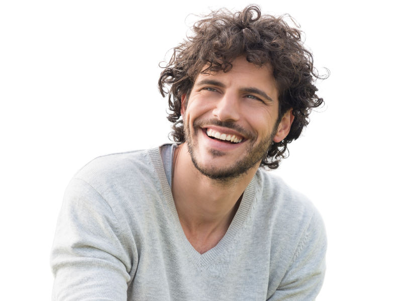 A man with curly hair and a beard is smiling.