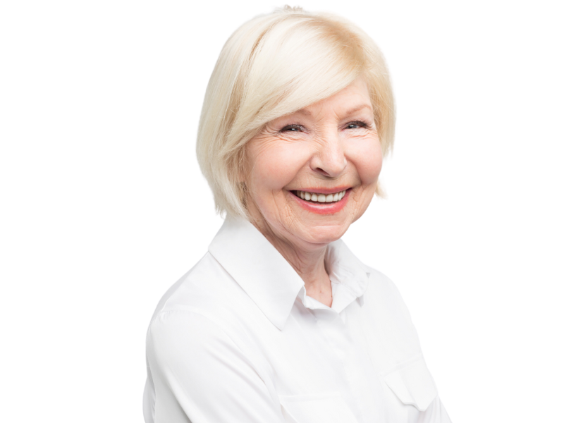 An elderly woman is smiling and wearing a white shirt.