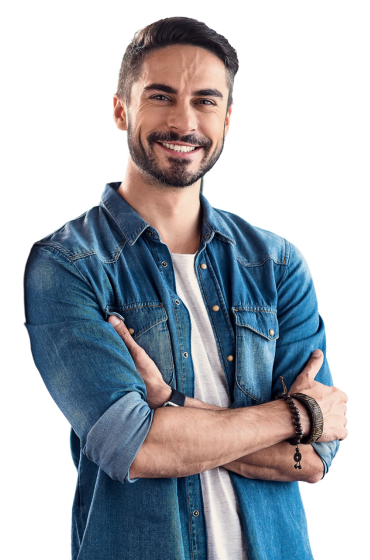 A man with a beard is standing with his arms crossed and smiling.