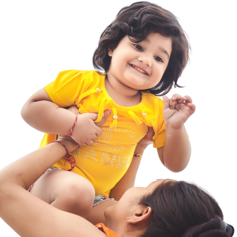 A woman is holding a little girl in her arms
