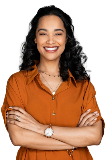 A woman in an orange shirt is smiling with her arms crossed