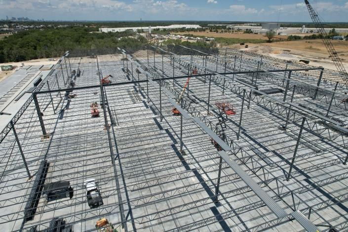 Construction workers on a steel framework of a large building under construction