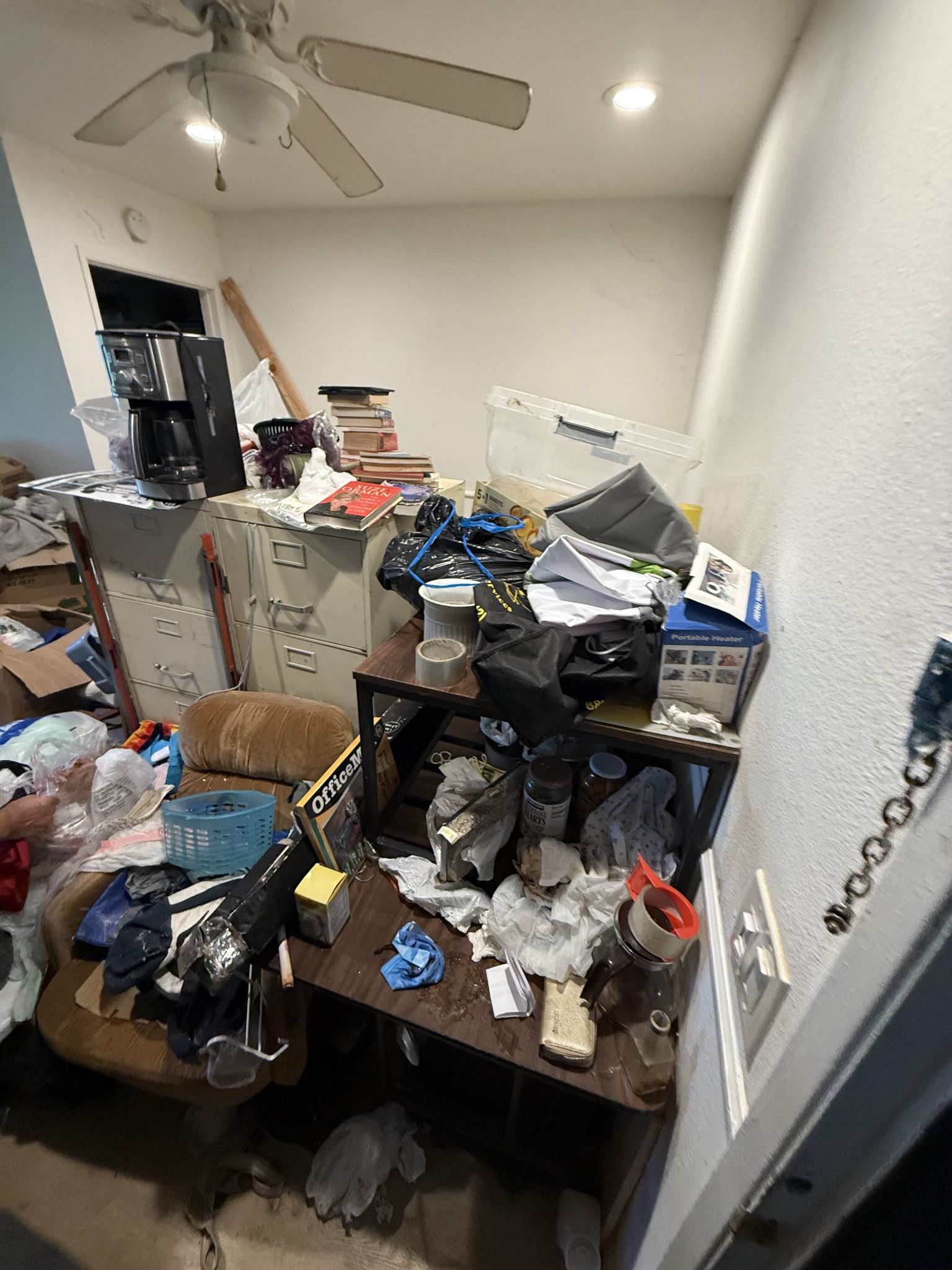 Cluttered dining area before a hoarder cleanout in Rancho Palos Verdes