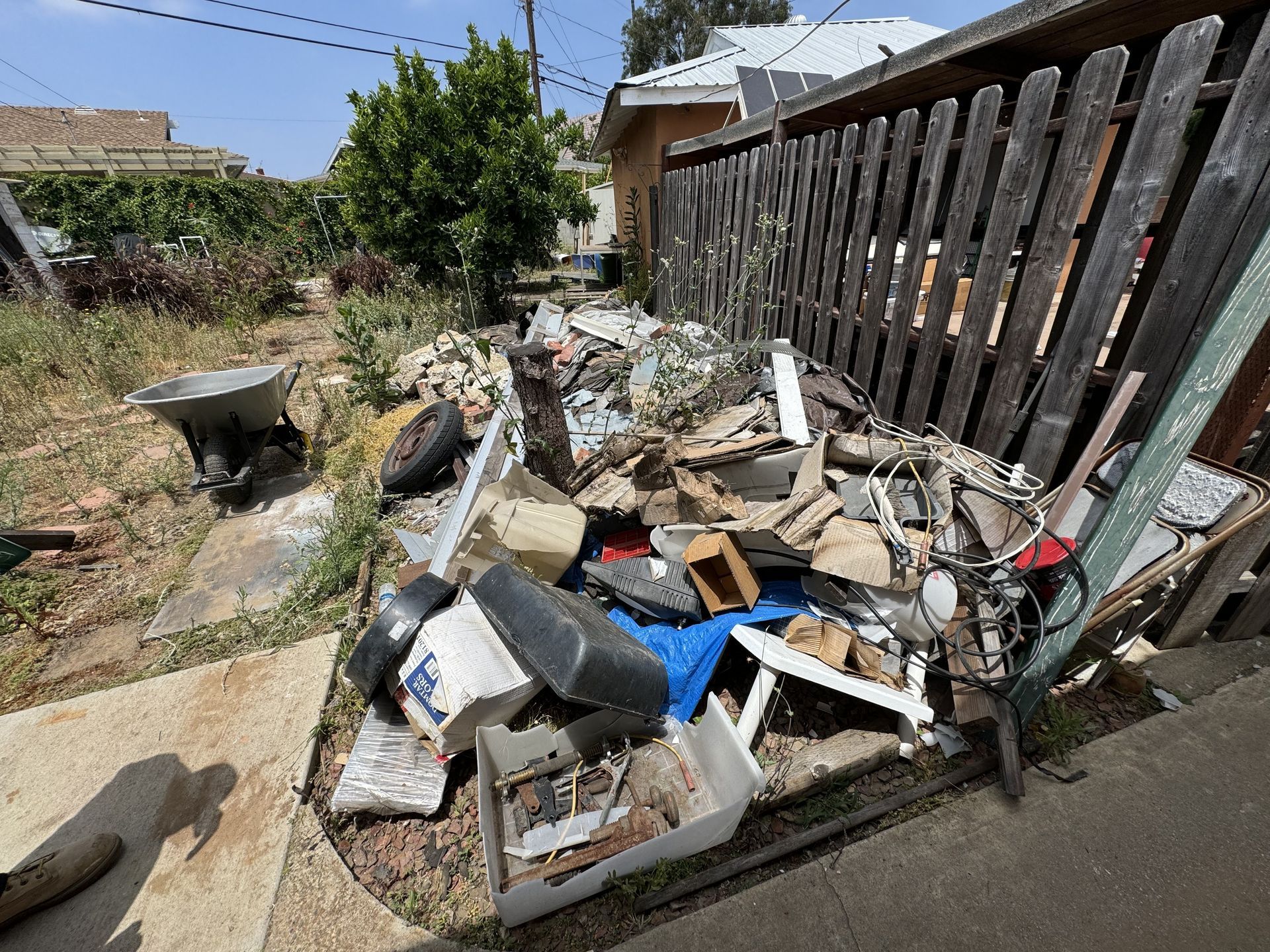 Cluttered backyard before a hoarder cleanout in Torrance
