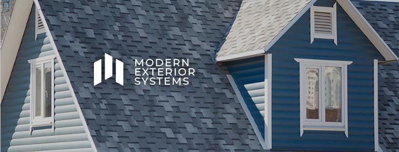 A blue house with a roof that says modern exterior systems on it.