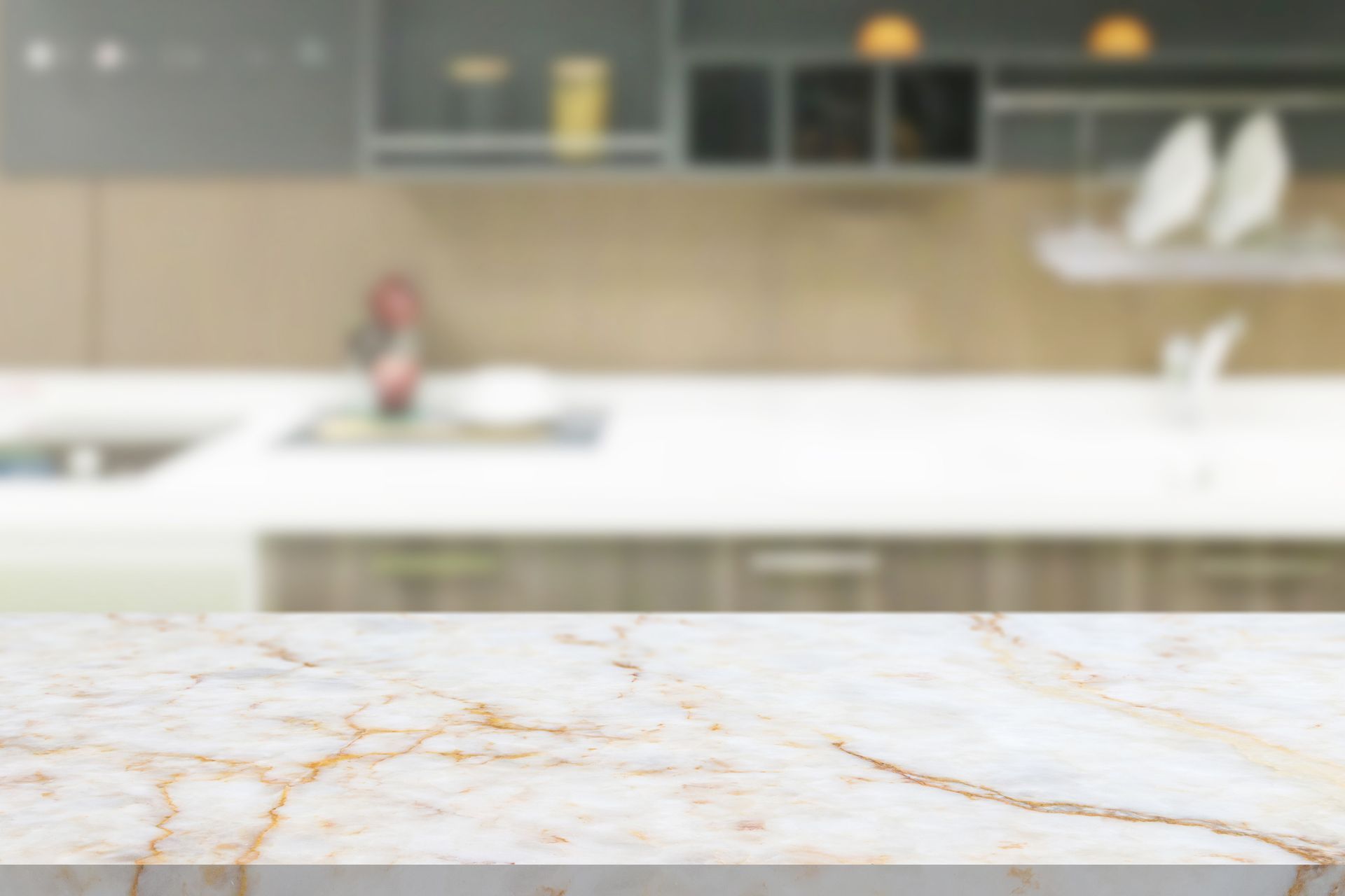 A marble counter top with a blurred kitchen in the background.