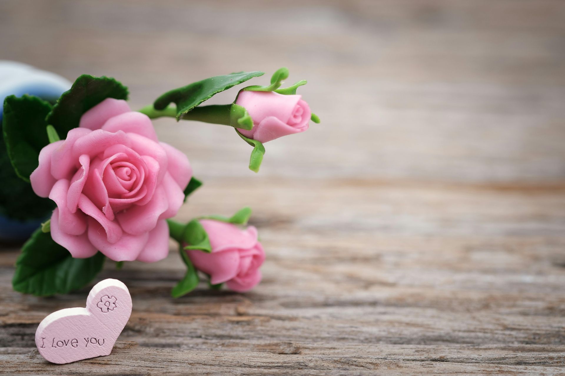 Pink roses with a heart that says