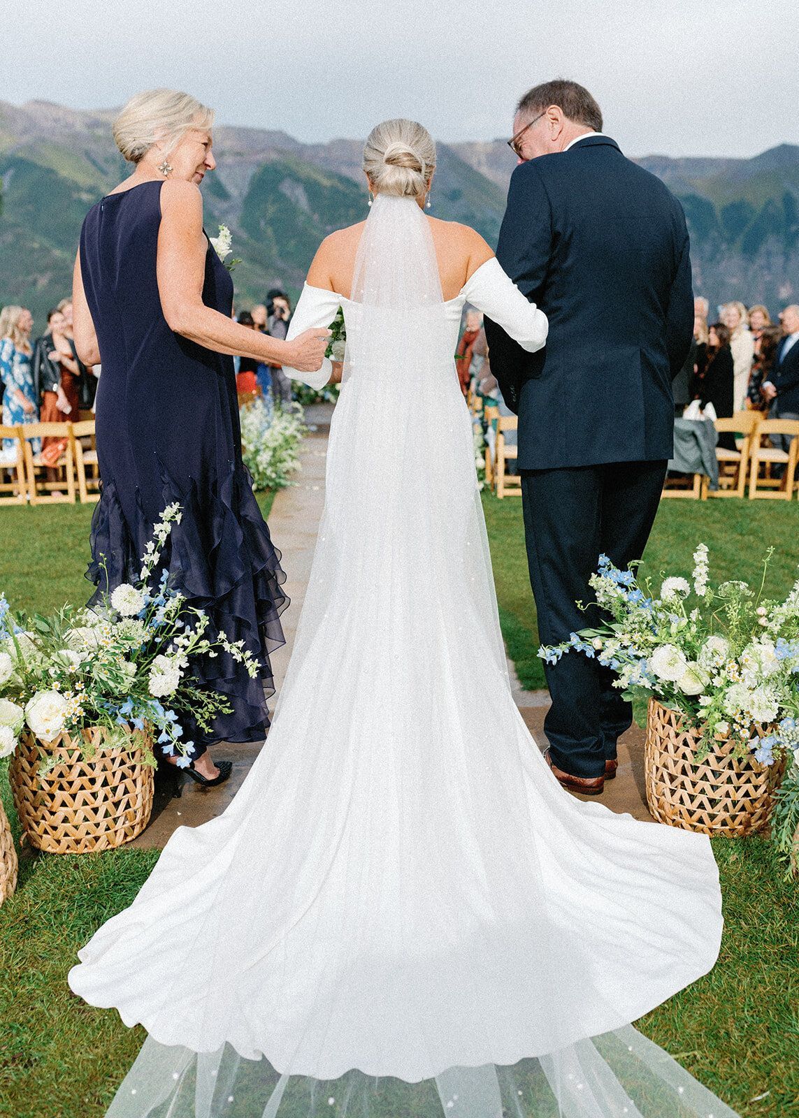 A bride and groom are walking down the aisle at their wedding.