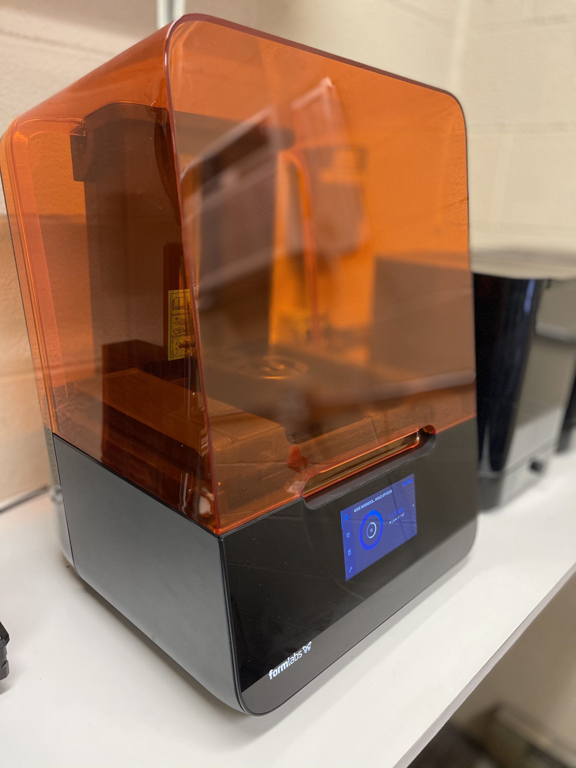 a 3d printer is sitting on top of a white table .