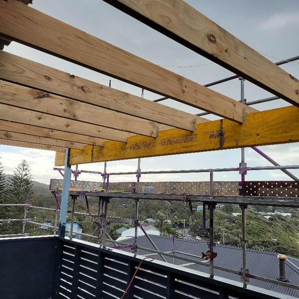 A Construction Site with Wooden Beams and Scaffolding — Coastline Building & Renovations In Boomerang Beach, NSW