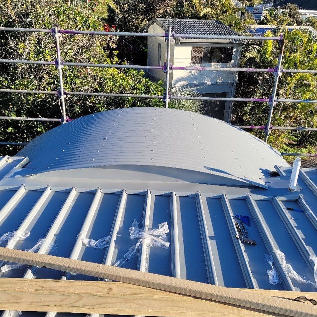 A Partially Constructed Metal Roof with A Domed Skylight — Coastline Building & Renovations In Tuncurry, NSW