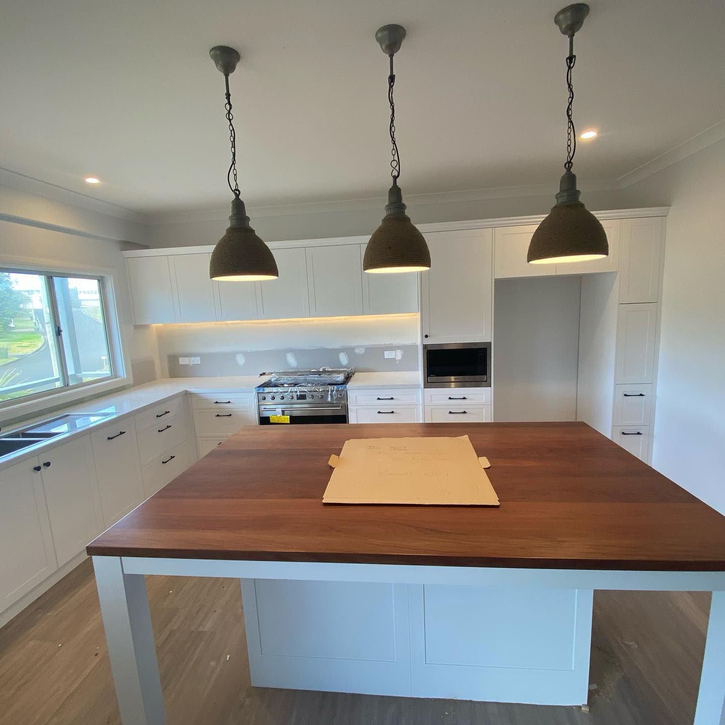 A Kitchen with White Cabinets — Coastline Building & Renovations In Tuncurry, NSW