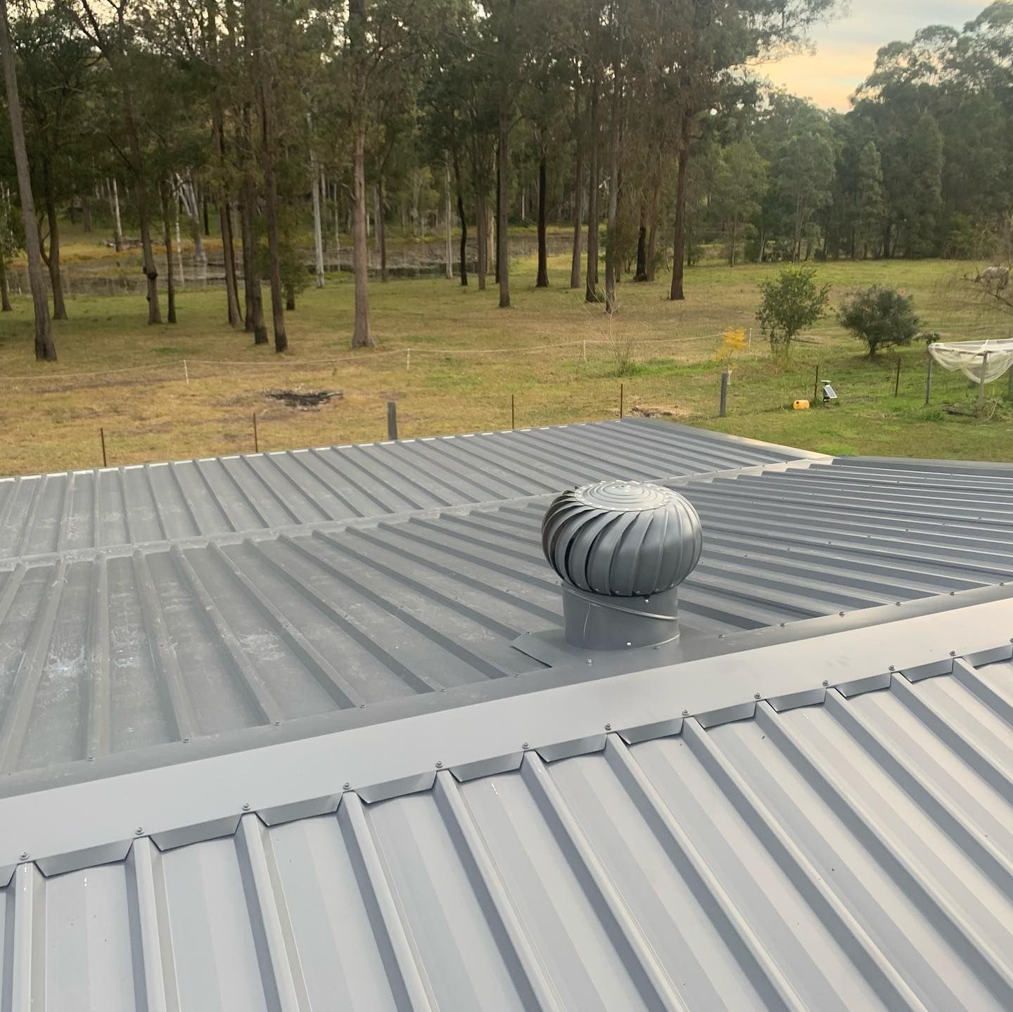 A Metal Roof with A Spinning Turbine — Coastline Building & Renovations In Pacific Palms, NSW
