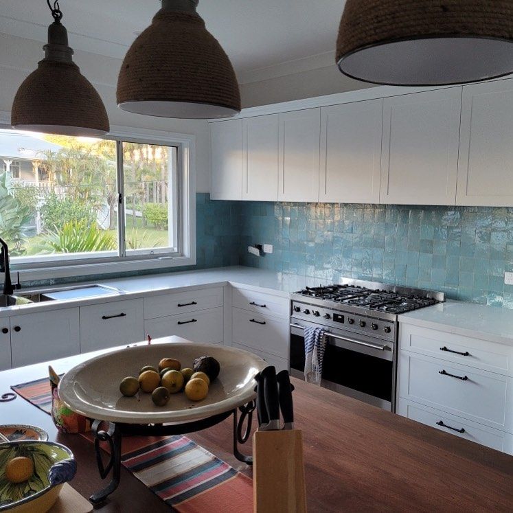 A Modern Kitchen with White Cabinets — Coastline Building & Renovations In Forster, NSW