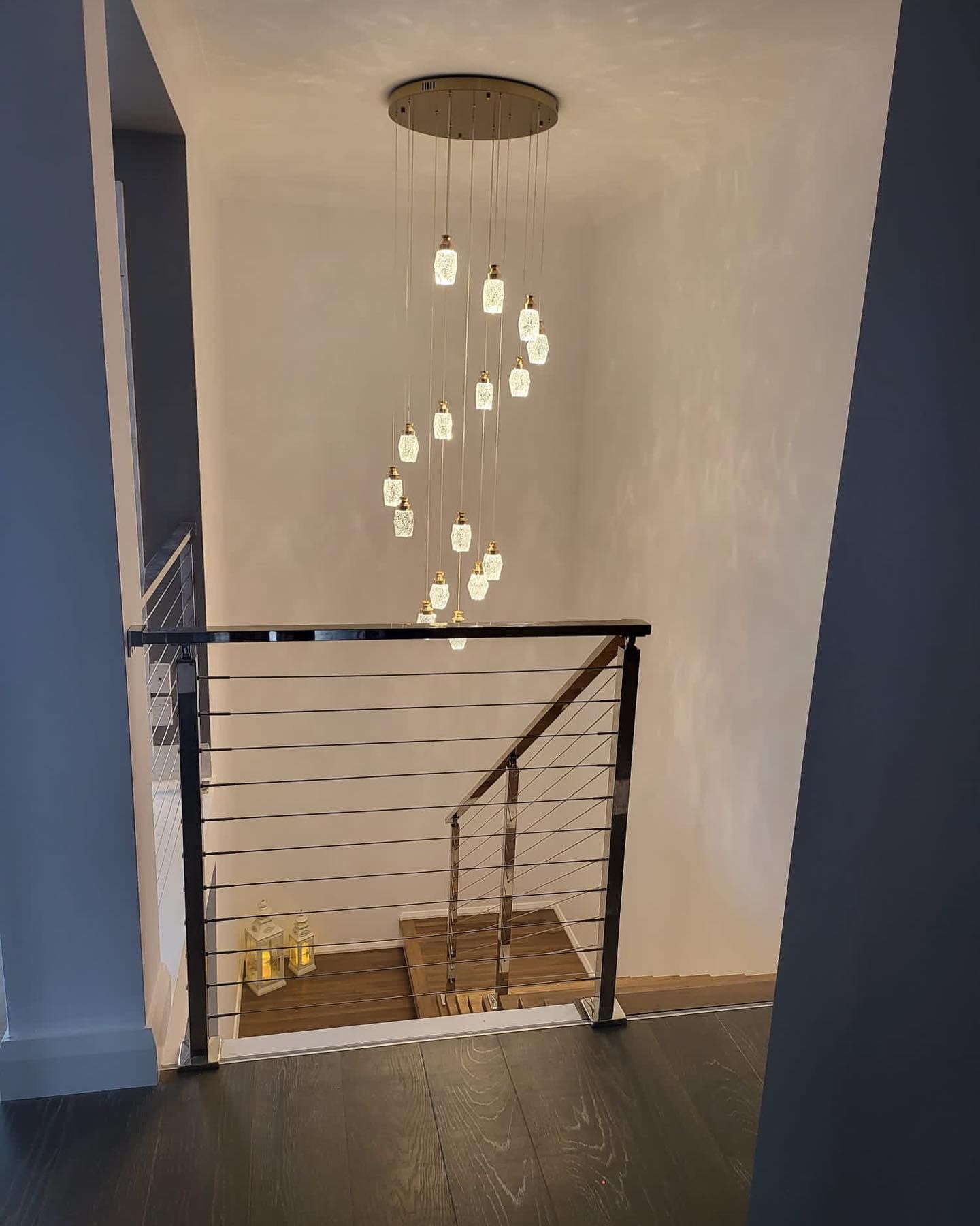 A Stairwell with Modern Chandelier — Coastline Building & Renovations In Forster, NSW