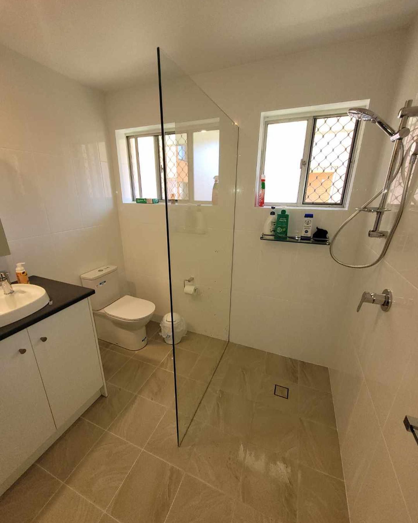 A Bathroom with Glass Shower — Coastline Building & Renovations In Boomerang Beach, NSW