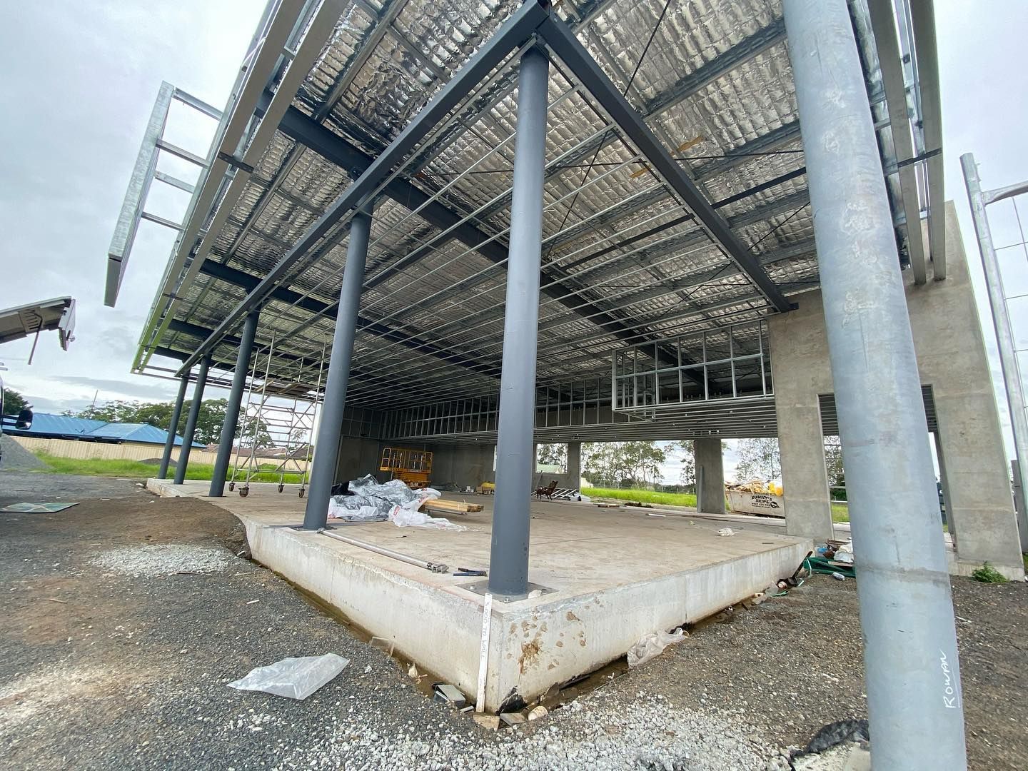 A Partially Constructed Building with A Solar Panel Roof — Coastline Building & Renovations In Tuncurry, NSW