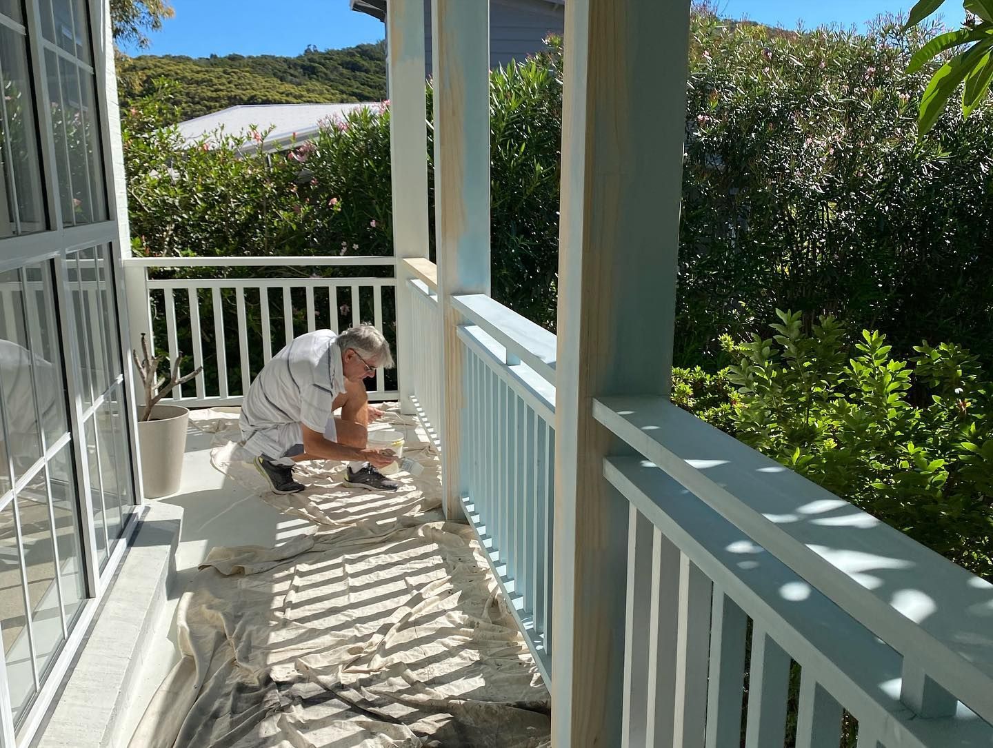 A Man Painting a Porch Railing — Coastline Building & Renovations In Forster, NSW