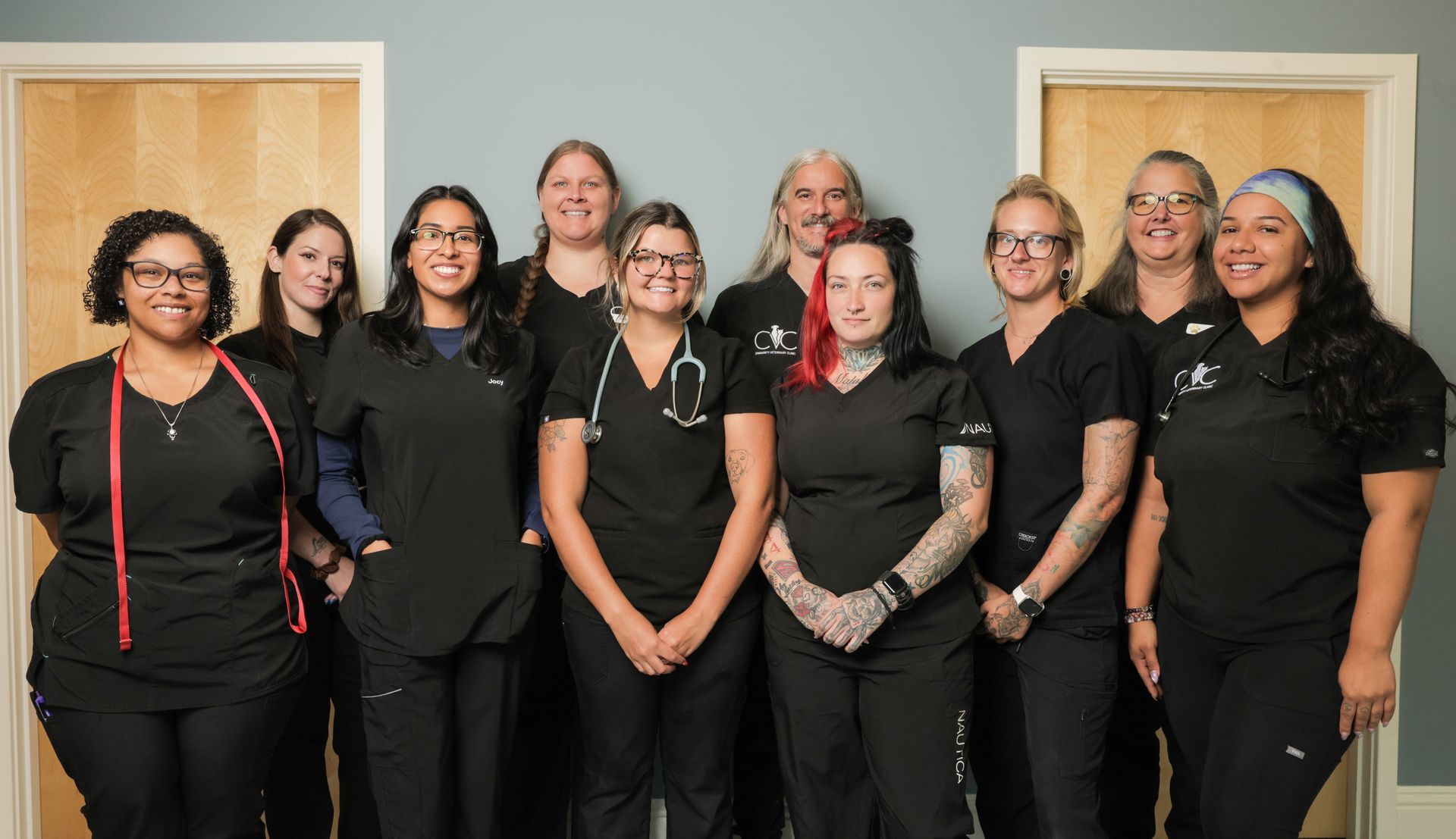 three women wearing black scrubs with the letters cvc on them