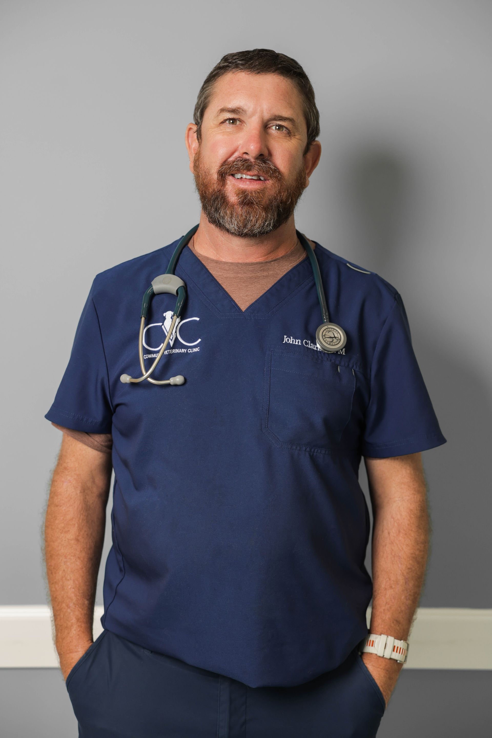 a man with a beard is wearing a shirt that says cvc. Dr. John Clark