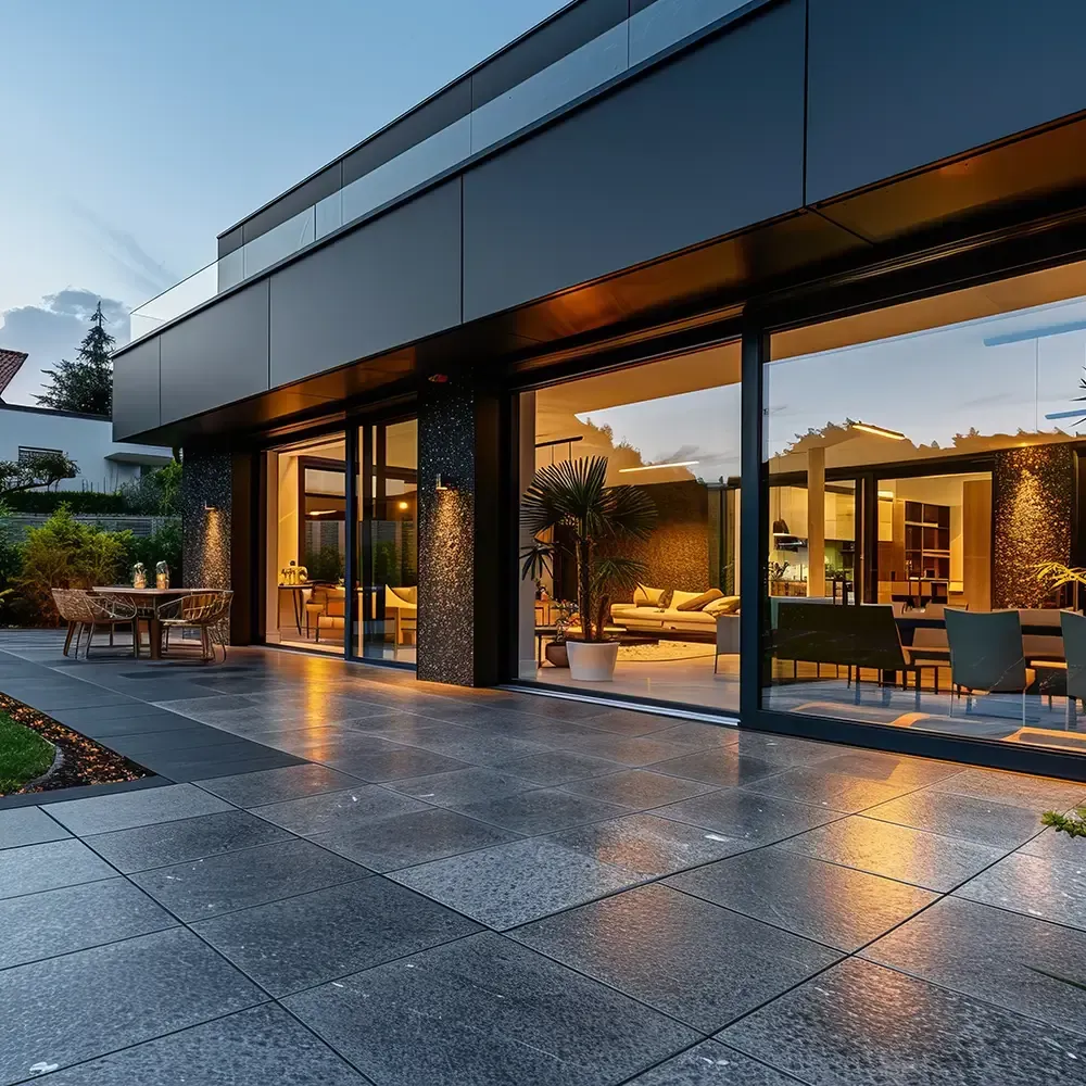 A large house with a lot of windows and a patio