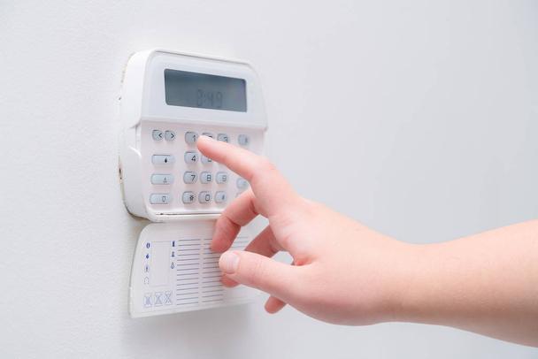 Hand pressing button on keypad 