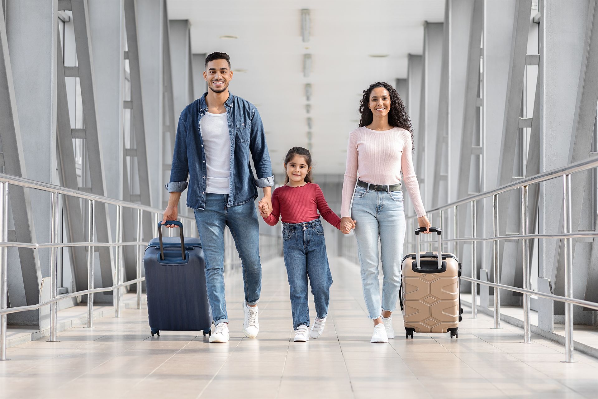 Family Walking Through an Airport With Luggage