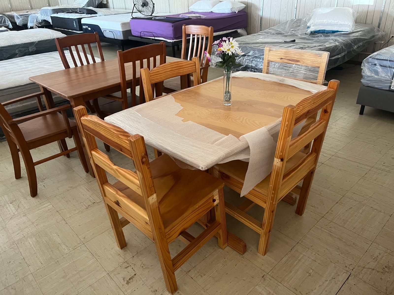 Wooden dining table and chairs displayed in a furniture showroom