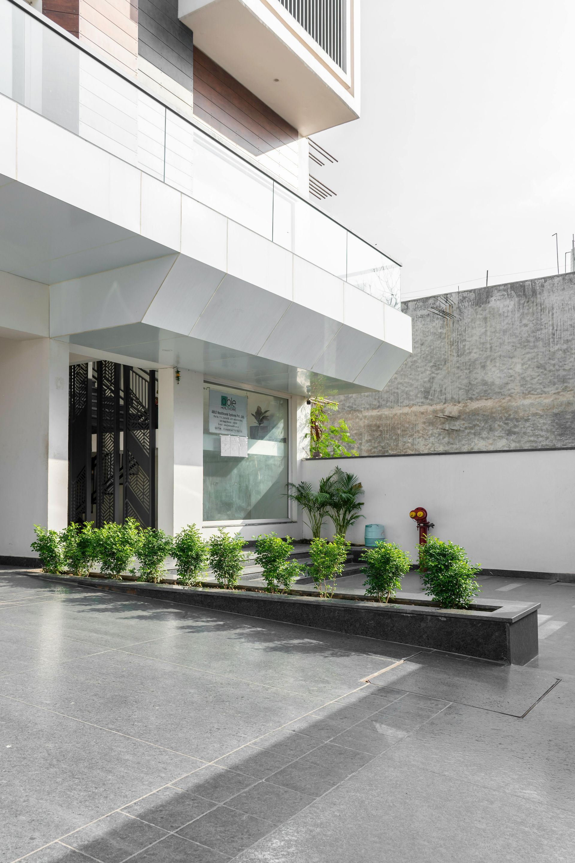 Outside a commercial building with some greenery in the middle.