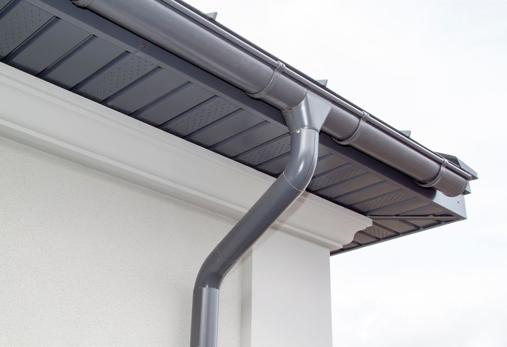 Gray Gutter System On A White Building — Your Garden in Belconnen, ACT