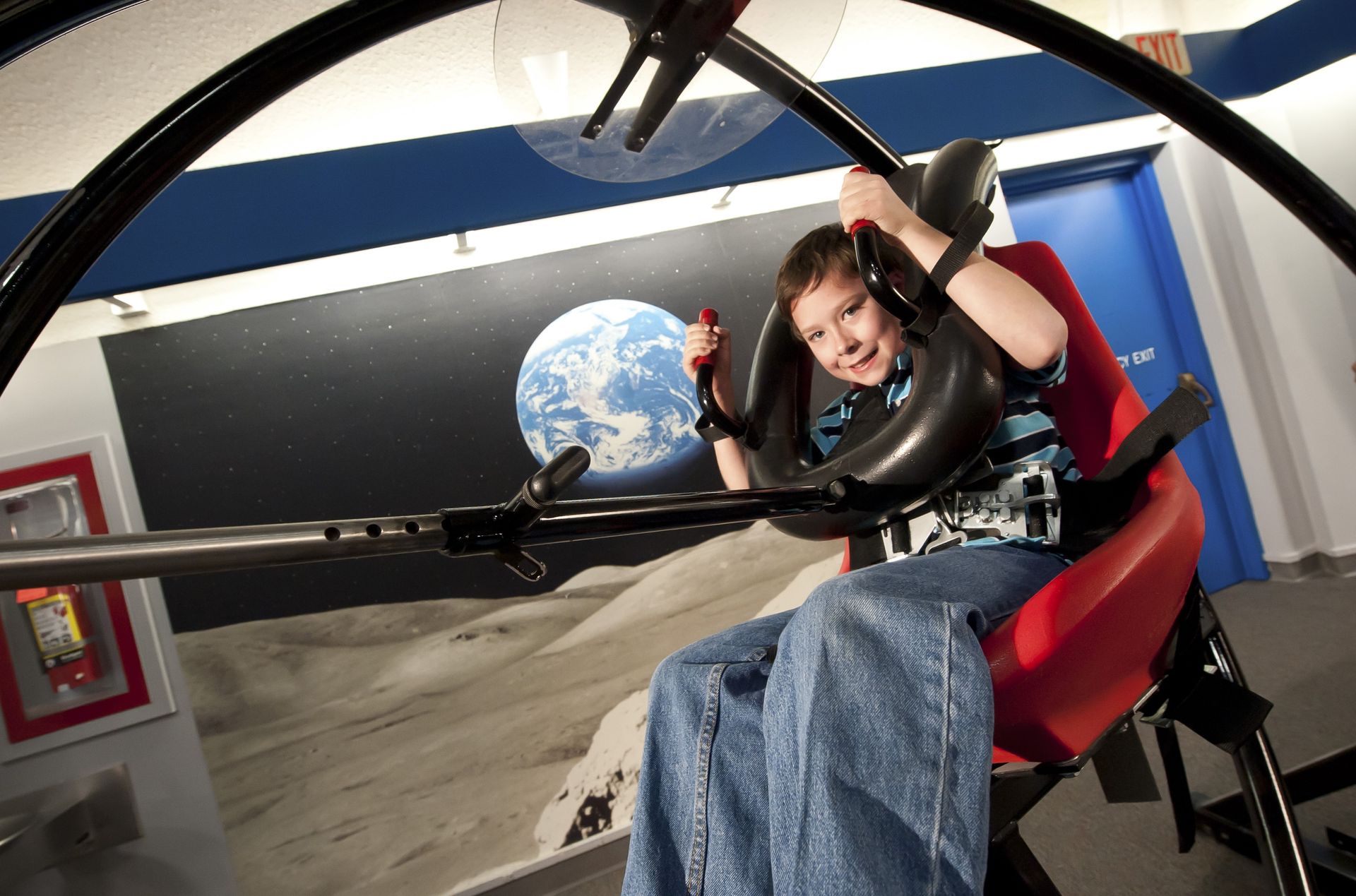 A person sits in a astronaut trainer chair at the Kansas Cosmosphere in Hutchinson, Kansas.