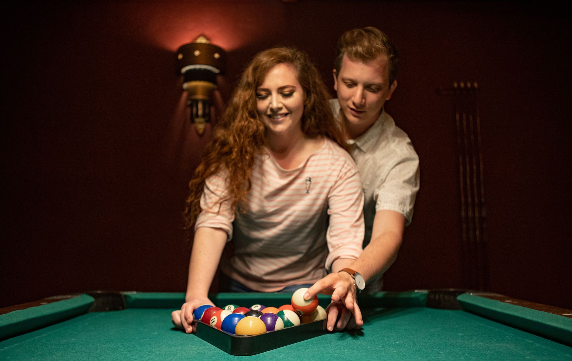 Couple playing pool. 
