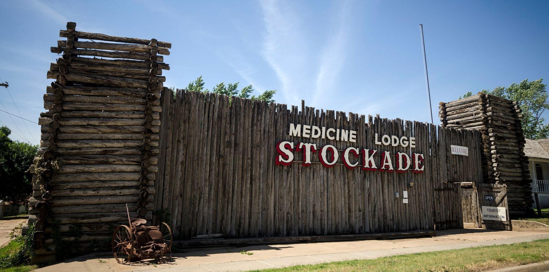 A wooden stockade wall with two corner towers, labeled 