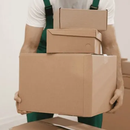 Person carrying stacked cardboard boxes in a moving setting