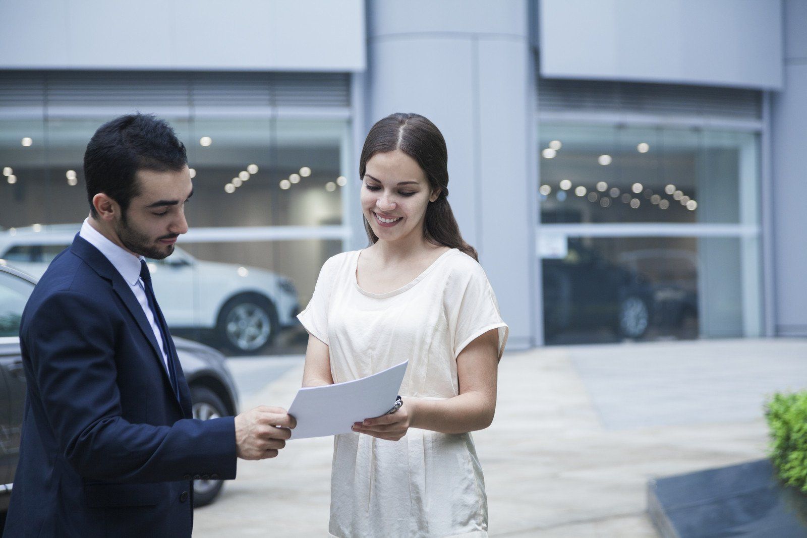 woman showing a paper to a man