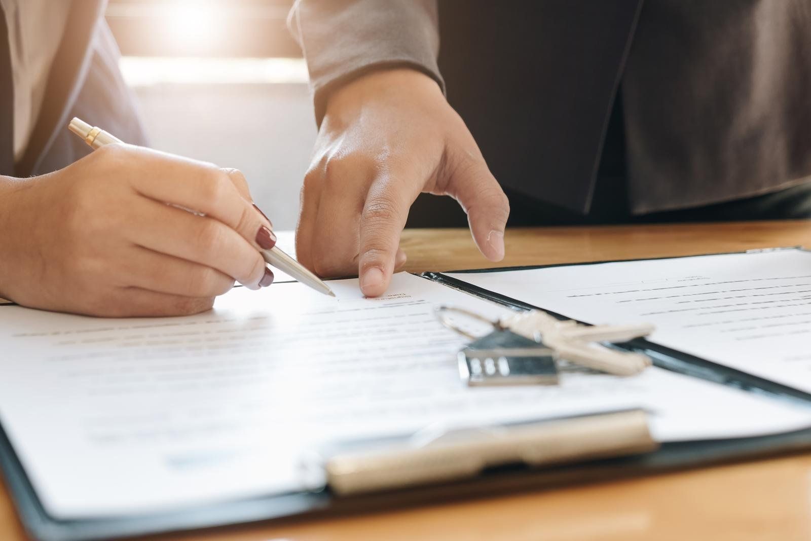 woman signing a contract