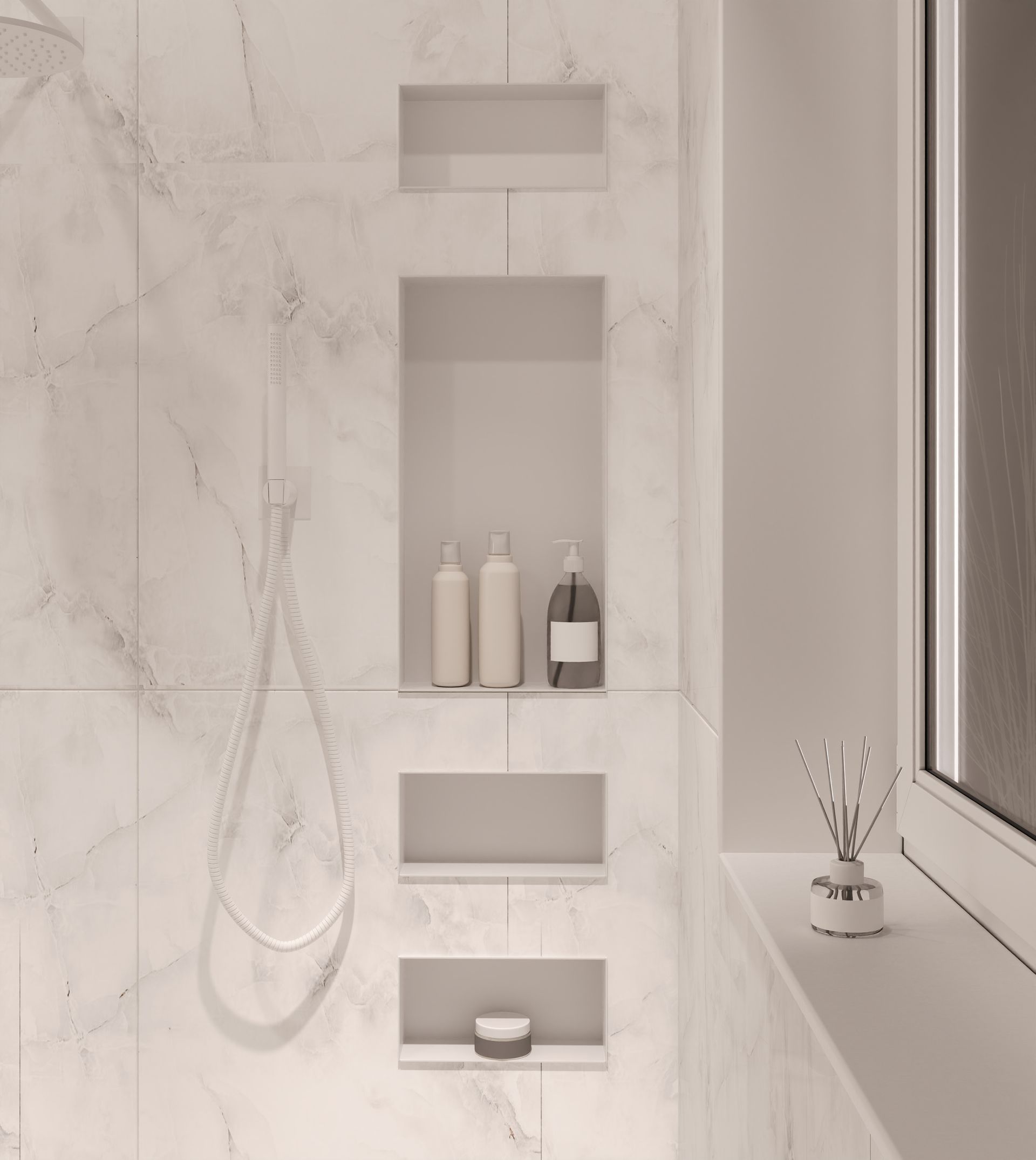 Shower with recessed shelves holding toiletries. Marble tile walls.