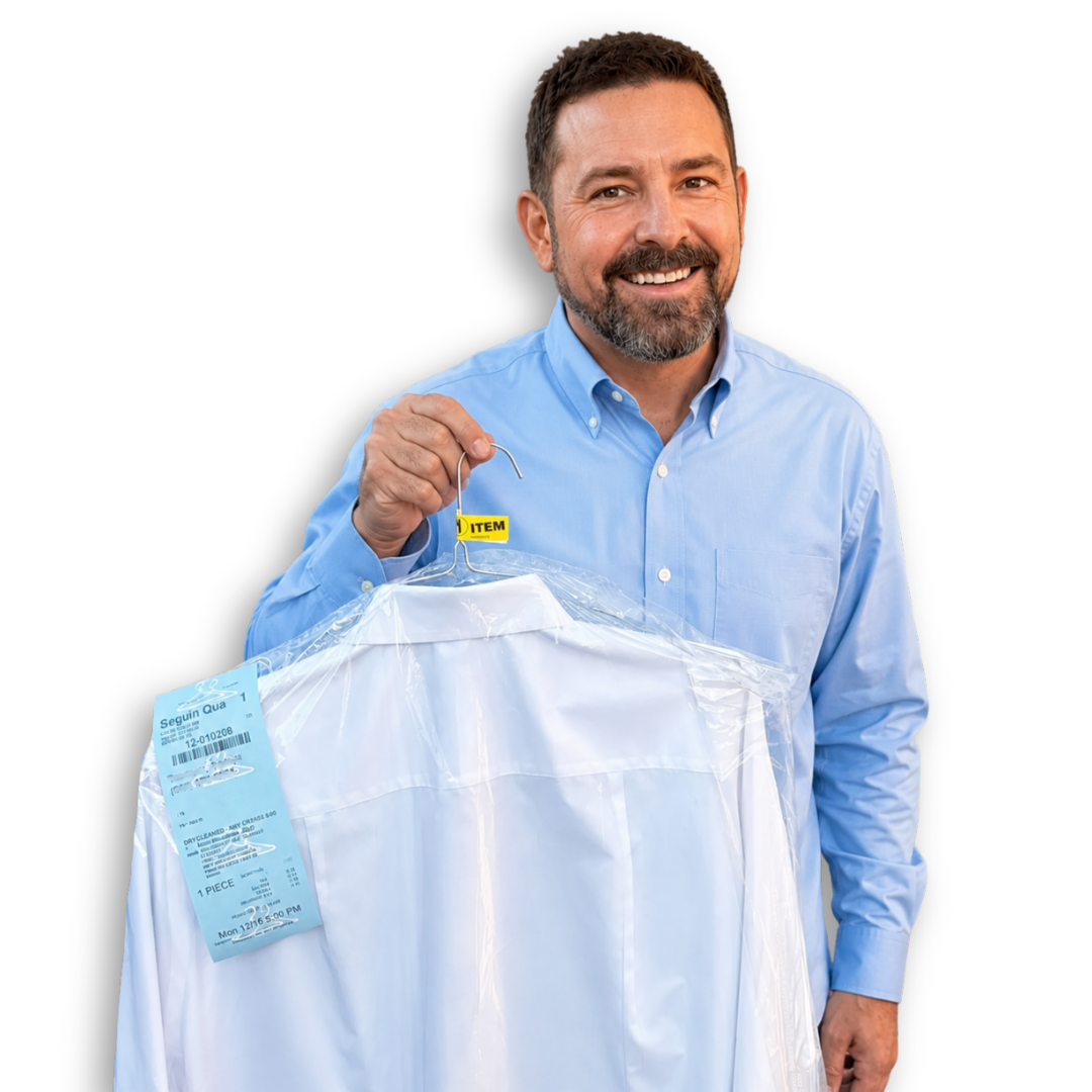 A man in a cowboy hat is holding a white shirt in a plastic bag