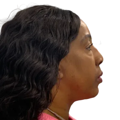 Profile view of a woman with wavy black hair against a plain white background