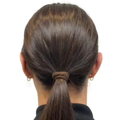 Back view of dark hair in a low ponytail with a knot, against a white background