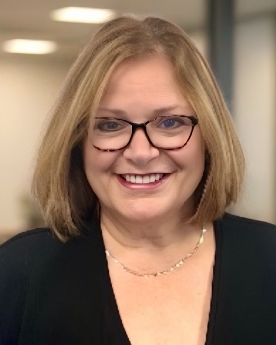 A close up of a woman wearing glasses and smiling