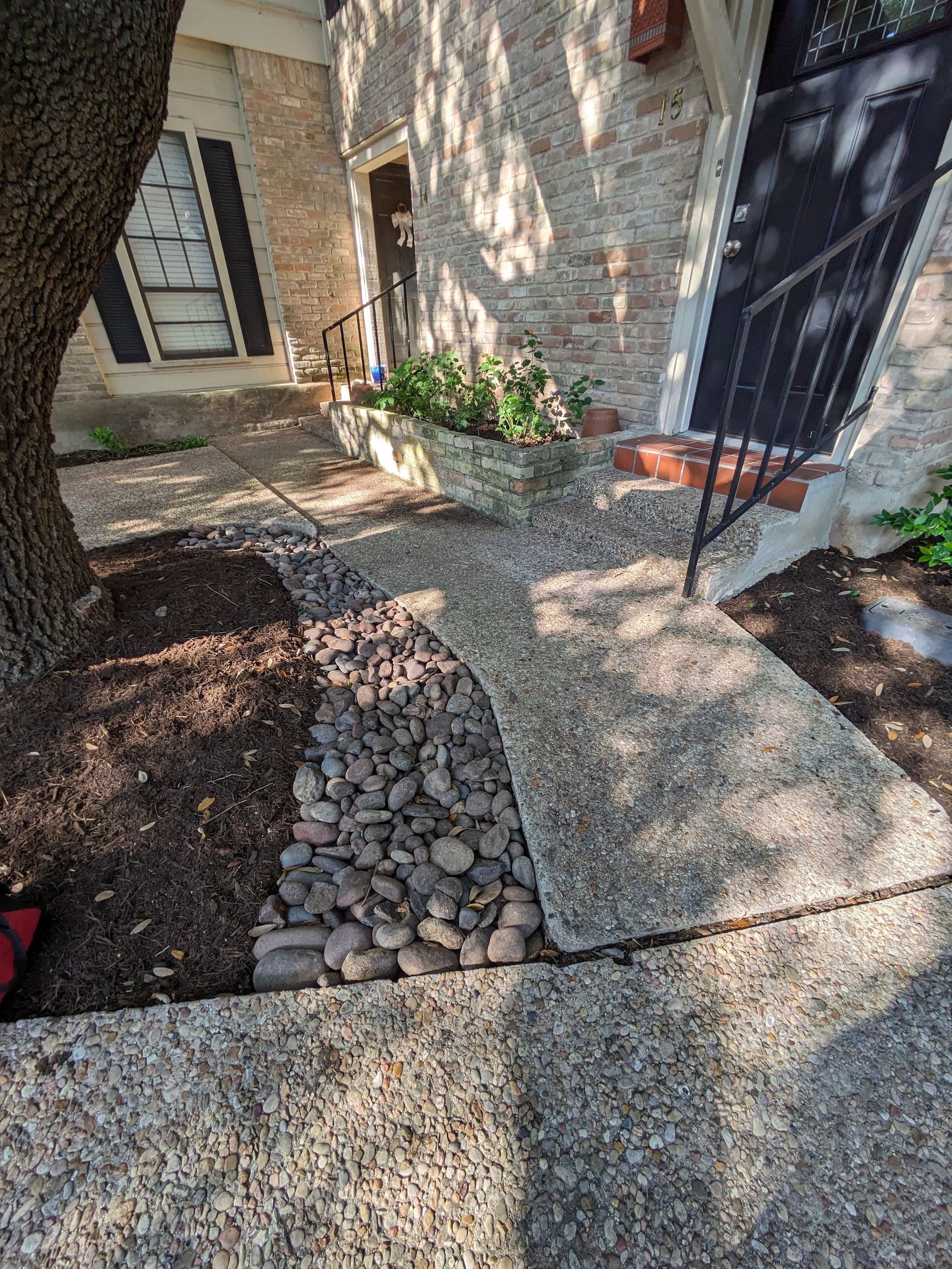 A stone walkway leading to the front door of a house.