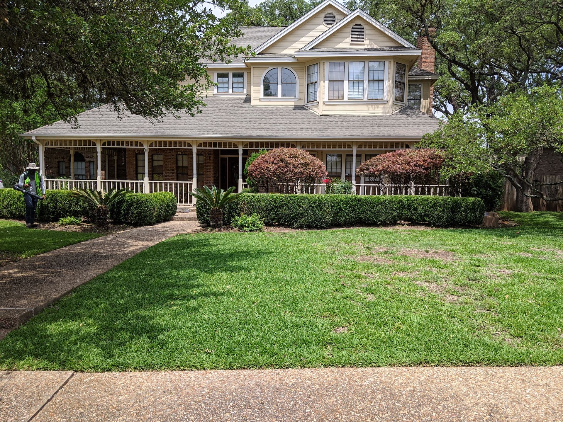 A large house with a large lawn in front of it.