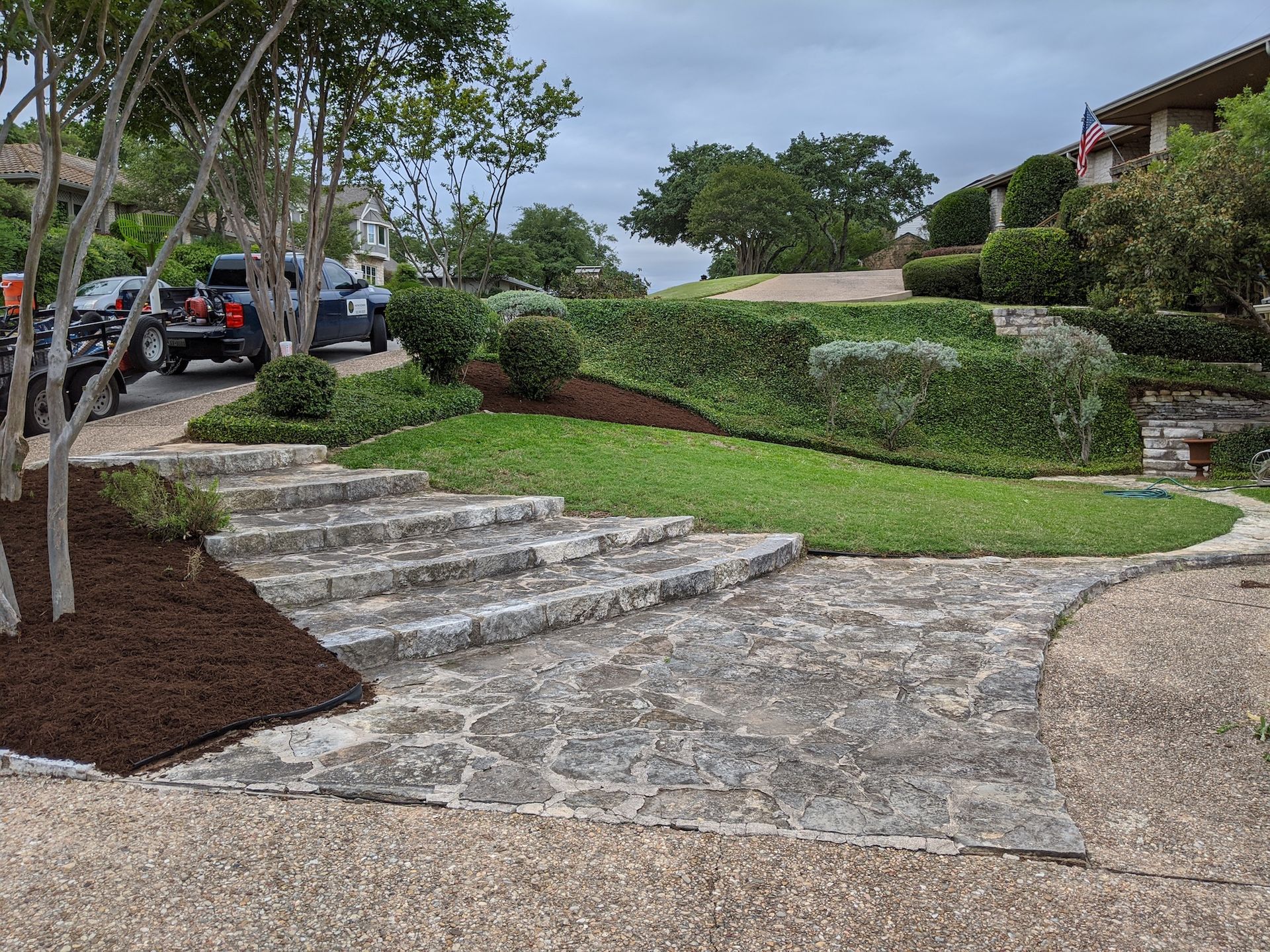 A house with a flag in front of it and a garden in front of it.