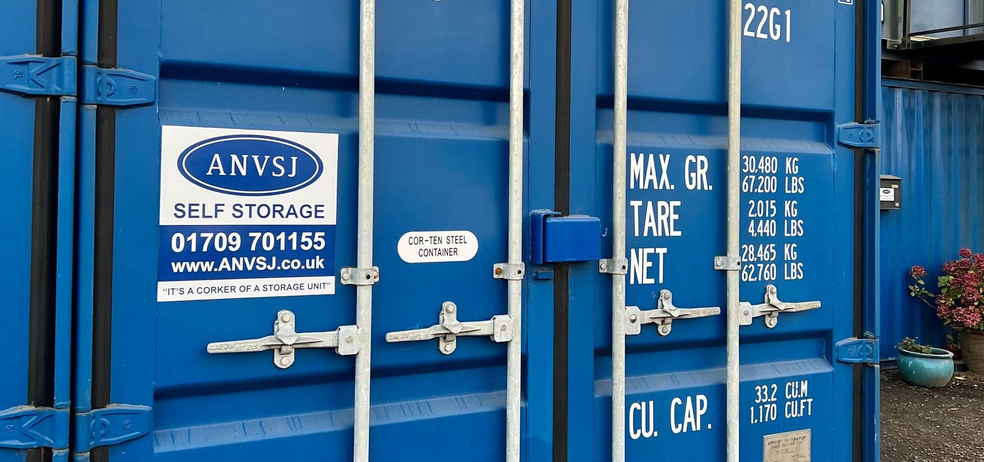 blue storage container with the company name and number on it