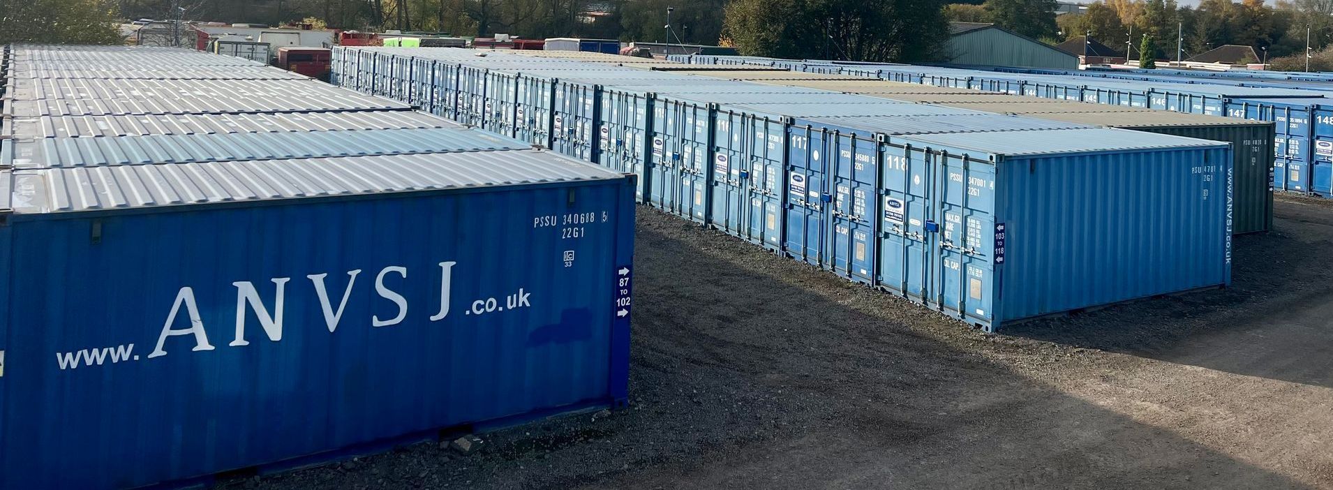 Rows of blue storage shipping containers labeled with 