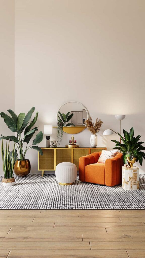 A modern living room with an orange armchair, a gold console table, a round mirror, plants, and a black-and-white rug.