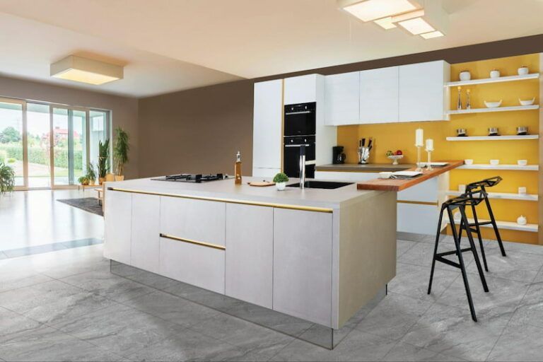 A modern kitchen with a white island, wooden countertop, yellow backsplash, open shelving, and black stools on grey floors.