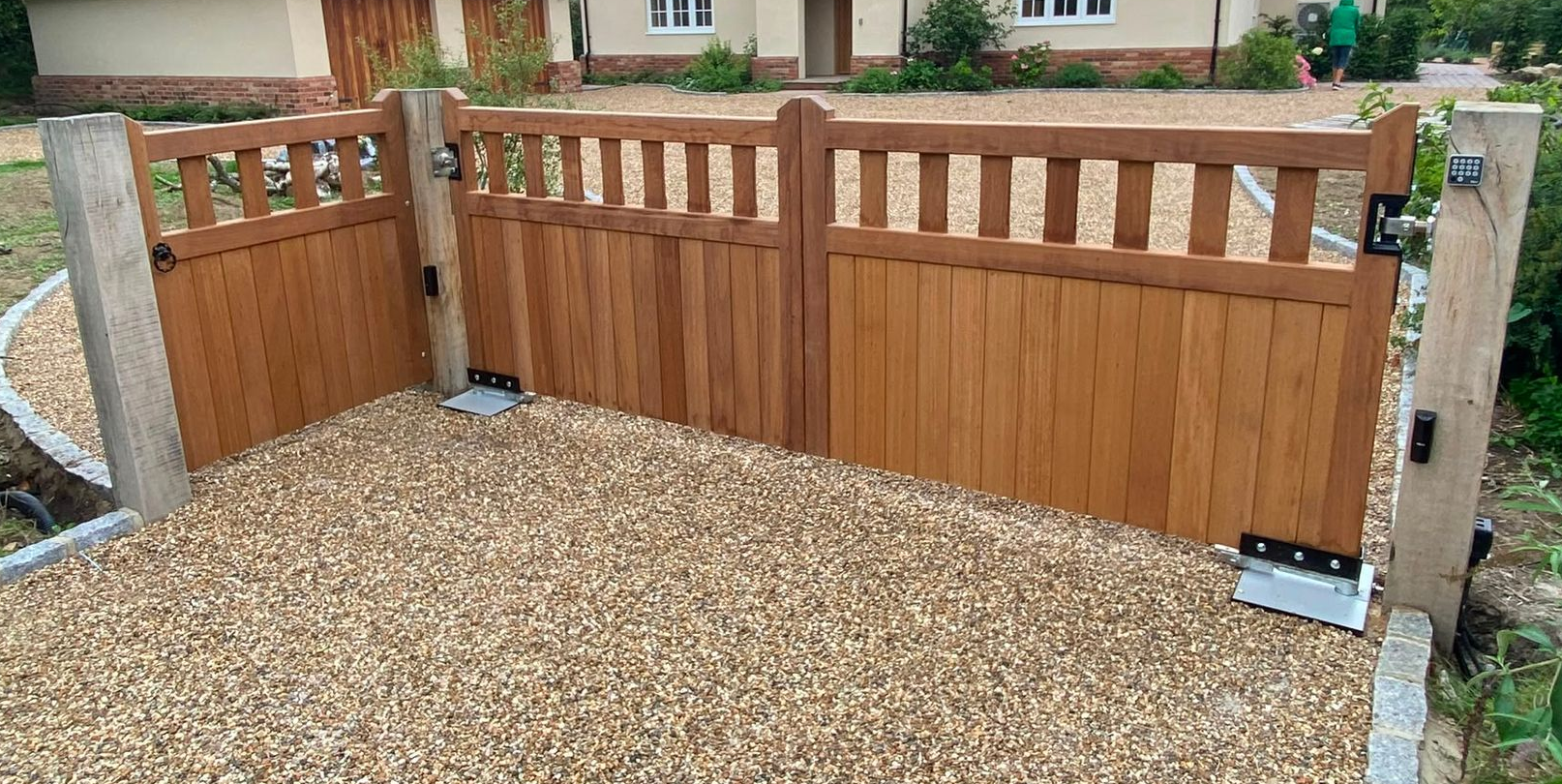 Iroko hardwood driveway gate with tongue-and-groove boarding and hit-and-miss slats