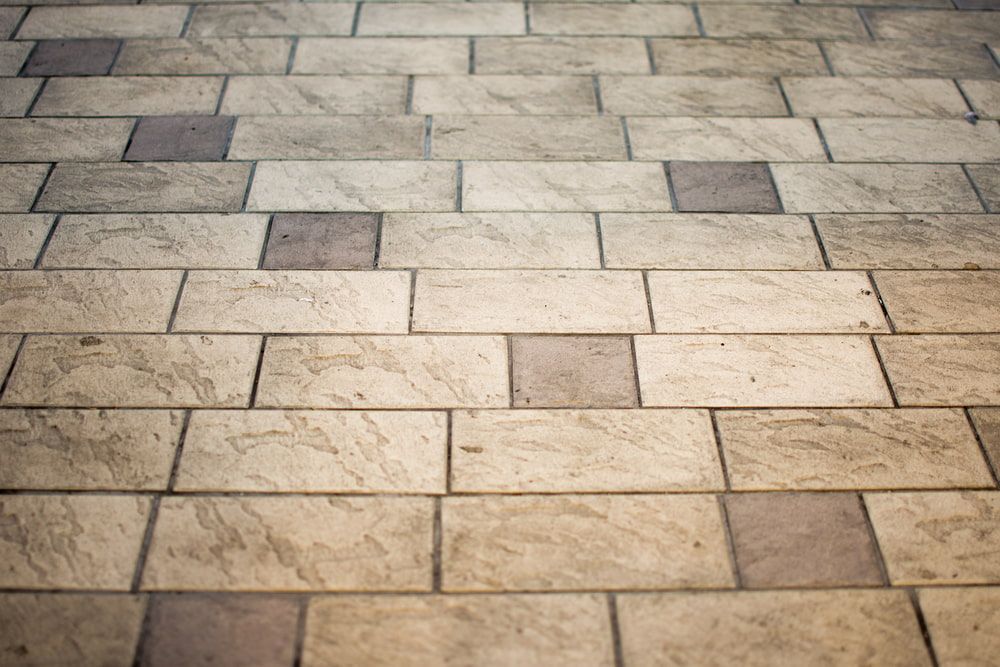 A Close Up Of A Tiled Floor With A Brick Pattern — Mid Coast Tiles Urunga In Urunga, NSW